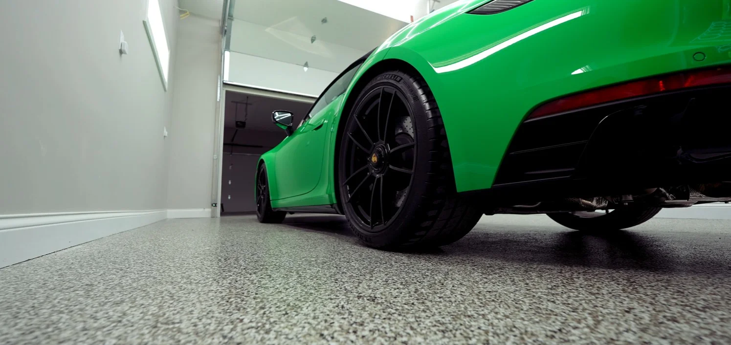 Porsche parked on a sleek epoxy garage floor coating